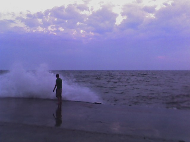 dude at the end of the grand haven pier, heavy seas 2