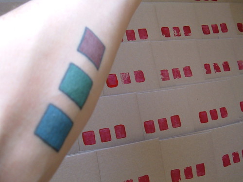 Red, green, and blue squares inside left forearm