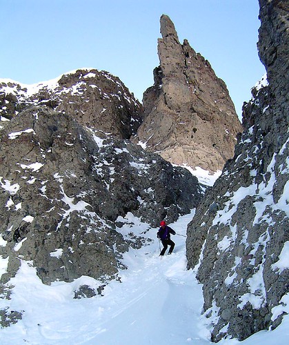 Skiing below a constriction with limestone pinnacle behind.
