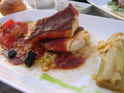 Pan-Seared Black Bass with Saffron Infused Tomato Broth, Yellow Split Peas, Confit Tomato and Braised Leeks