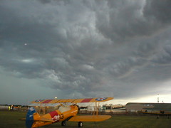 Biplane under storm clouds