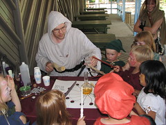 Pyroforius and his magical board; kids assist the spell with their wands