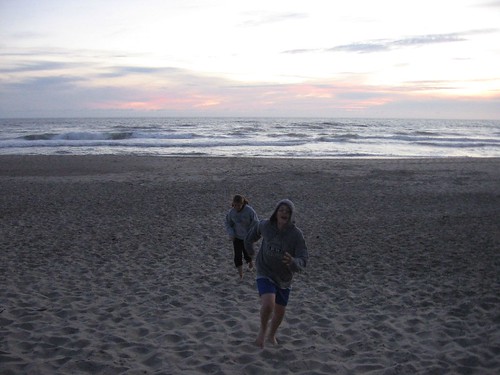 Iona and Calum racing across the sand in Lincoln City, Oregon