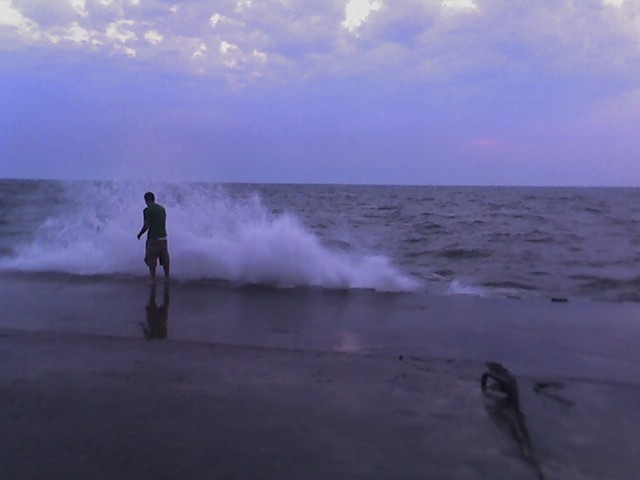 dude at the end of the grand haven pier, heavy seas 1