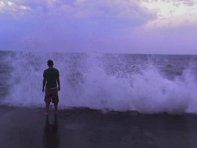 dude at the end of the grand haven pier, heavy seas 3
