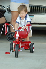 Ean pushing his new tricycle