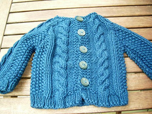 Baby sweater with cables