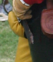codpiece-a detail of the outfit of theman at the lead of the parade with the big red flag