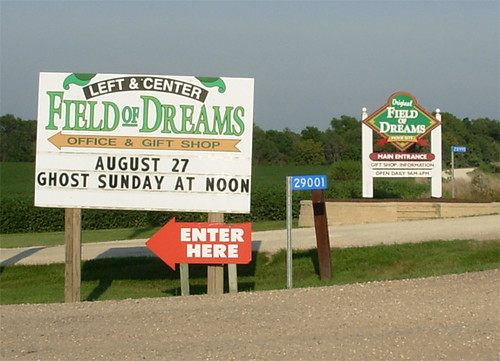 competing signs to entrance of field of dreams