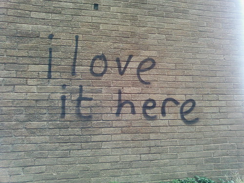 IMAGE: I LOVE IT HERE spray-painted across one of the University buildings.