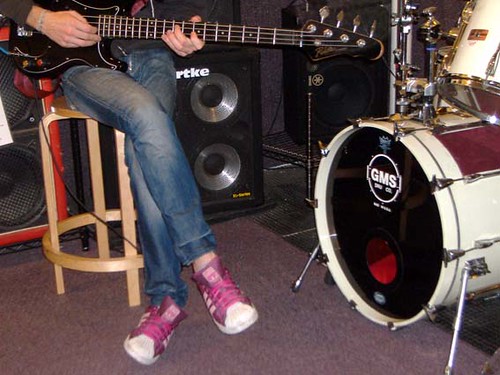 bass. maroon & pink sneakers. drum kit.