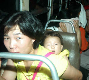 North Korean refugee woman and baby, Bankgok, Thailand.  The refugees risked arrest and repatriation to North Korean gulags -- or worse -- as they traveled thousands of miles along a modern-day underground railroad.