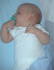 Matthew holding on to his pacifier - 8 weeks.
