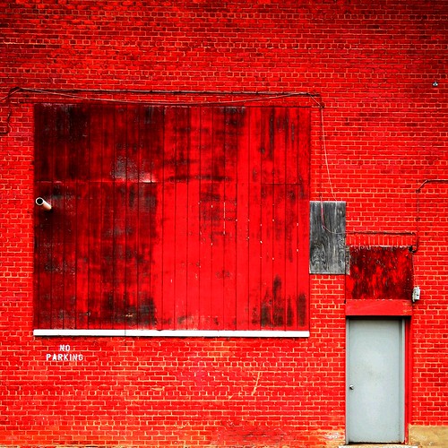 a red brick wall in the colour of a brick-red crayola