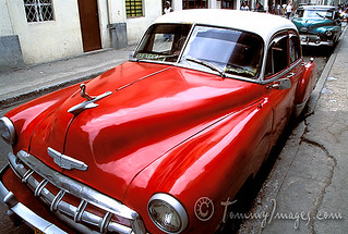 A red classic car sits in Havana