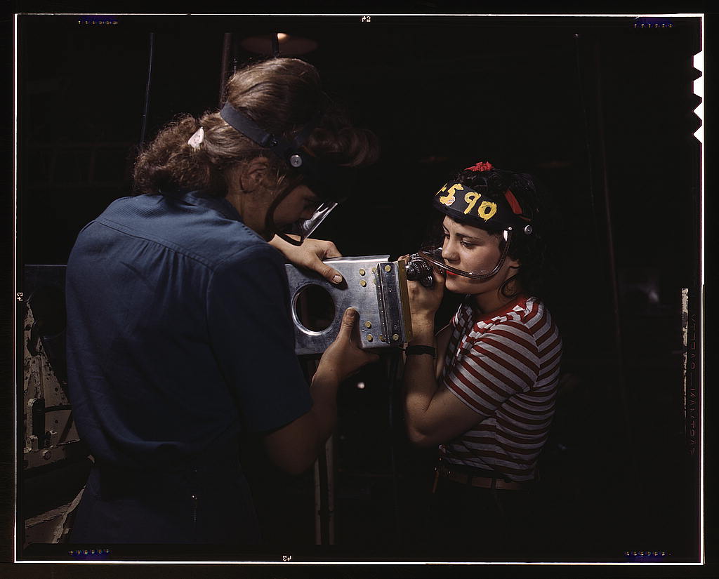 Two women employees of North American Aviation, Incorporated, assembling a section of a wing for a P-51 fighter plane (LOC)