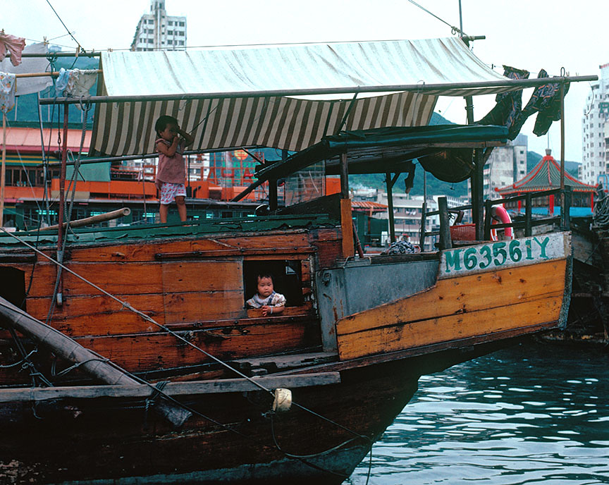 Kids on Chinese junk, Hong Kong harbor