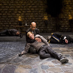 Horatio (Kareem Bandealy) and Hamlet (Scott Parkinson).  Laertes (Timothy Edward Kane) and Claudius (Michael Canavan) in background in HAMLET at Writers' Theatre. Photo by Michael Brosilow.